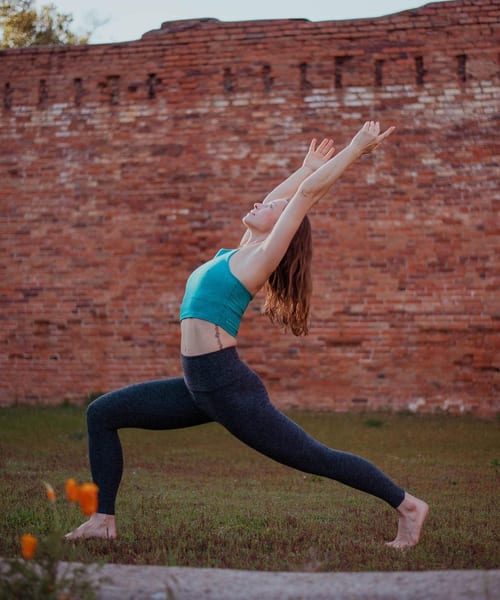 Handstand yoga pose through brick archway